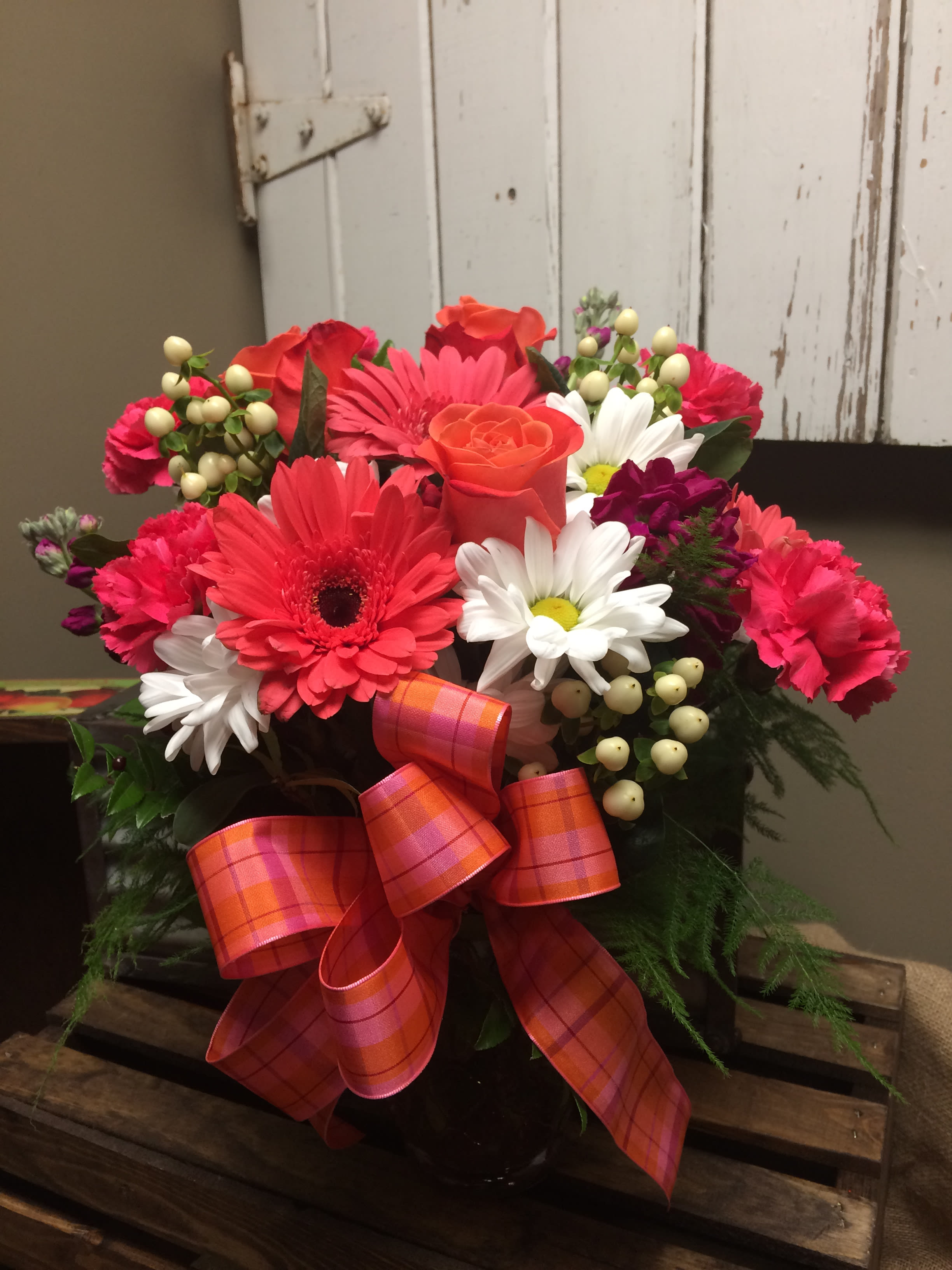 Make Today Bright Custom Design by Cold Spring Floral Make Today Bright Custom Design by Cold Spring Floral - A collection of bright cheery flowers such as hot pink gerbera daisies and carnation, orange roses, fuchsia stock, white daisies and hypericum berry. Accompanied with mixed fresh greenery and a held in a colored glass vase. Colors and exact varieties of flowers vary due to availability and vase color can change to coordinate with flowers.
