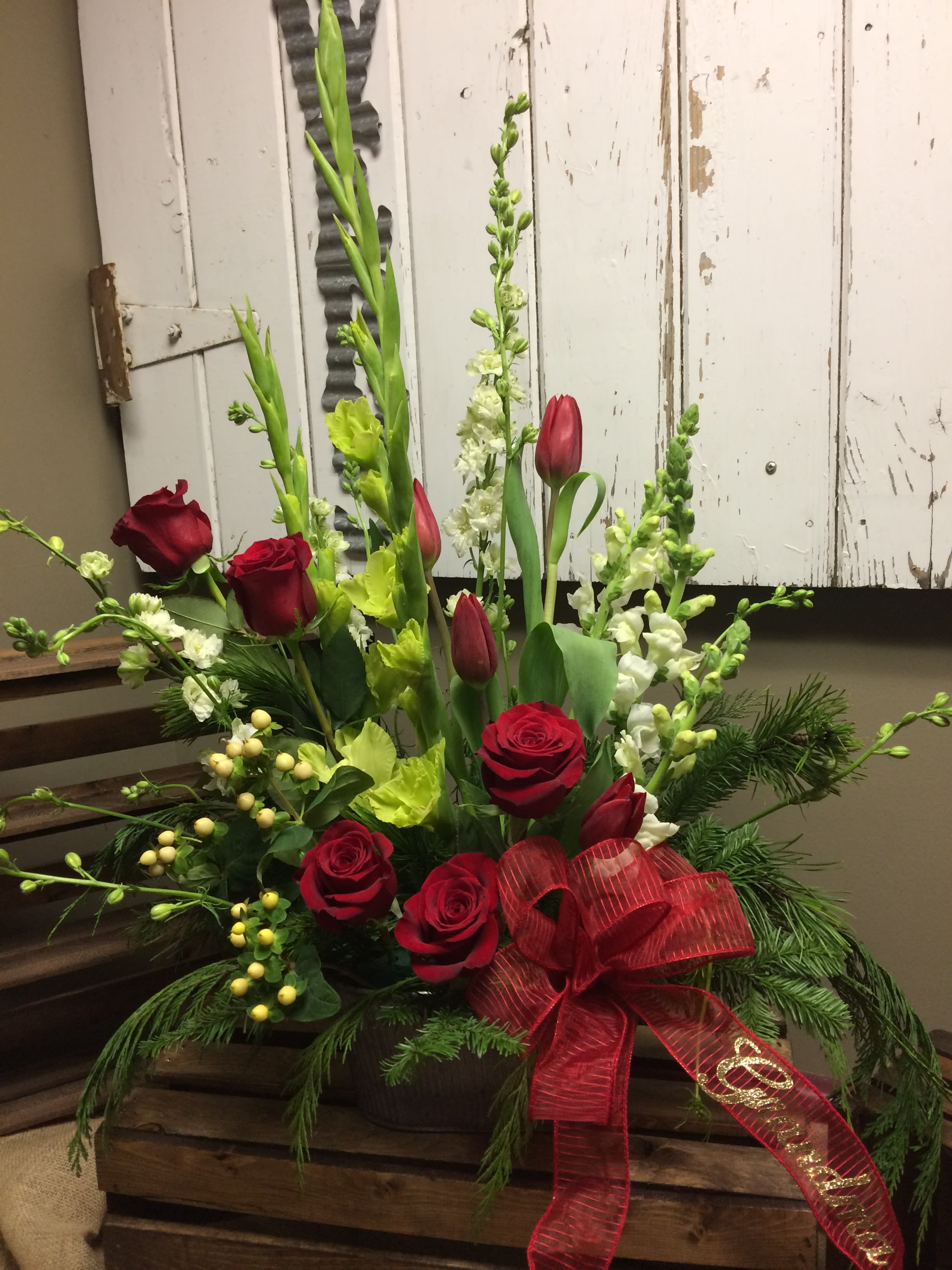 Peace and Comfort  designed by Cold Spring Floral - Designed in a basket with green gladiolas, white larkspur, red roses, white snaps, red tulips, in a bed of lush greens