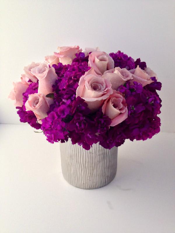 French Kiss - An arrangement of hydrangea, sweet William, stock flower and light pink roses in silver vase.