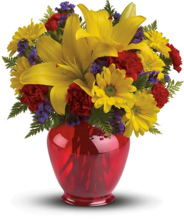 Let's Celebrate Bouquet - Celebrate with this joyous bouquet! Bring the sunshine in with golden lilies and bright yellow daisies in our charming red ginger jar vase.  This bright bouquet includes yellow asiatic lilies, miniature red carnations, yellow daisy chrysanthemums, purple statice and fresh leatherleaf fern. 