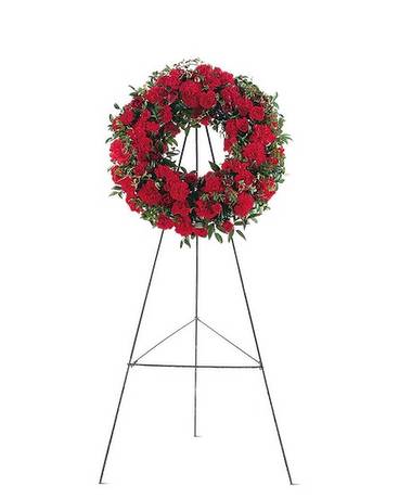 Red Regards Wreath Red Regards Wreath - This simple, yet stylish wreath shows the depth of your love and support. One wreath on an easel arrives with red carnations and roses, along with decorative natural foliages.