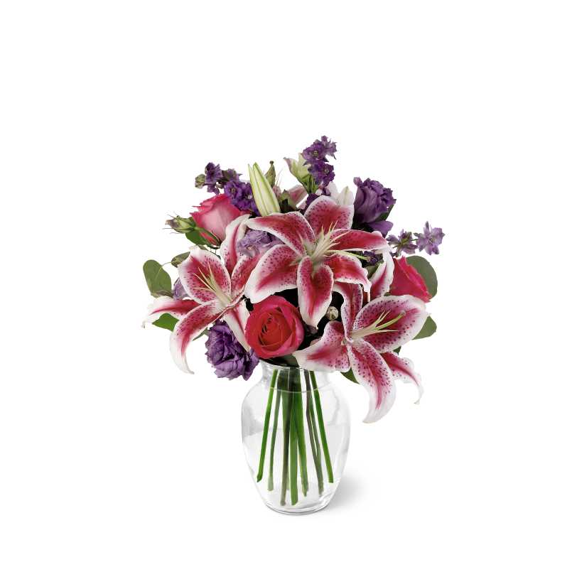 Bright &amp; Beautiful Bouquet - Bright hot pink roses, fragrant stargazer lilies, beautiful purple lisianthus and larkspur are arranged with silver dollar eucalyptus in an urn-shaped glass vase. This is a wonderful bouquet for anniversaries, birthdays, or any cause for celebration.