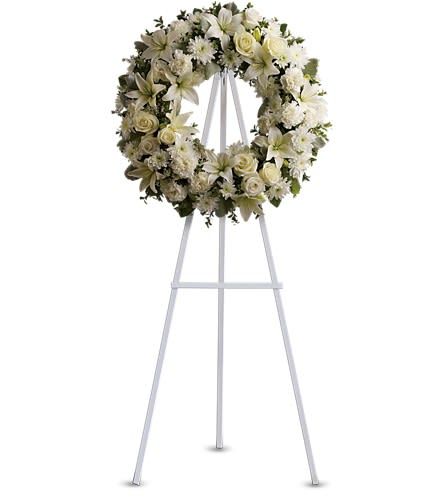 Serenity Wreath Serenity Wreath - A ring of fragrant bright white blossoms will create a serene display at any funeral or wake. This classic wreath is delivered on an easel and is a thoughtful expression of sympathy and admiration. A standing wreath created from fresh white flowers such as roses Asiatic lilies carnations and cushion spray chrysanthemums - accented with greenery - is delivered on an easel.Approximately 22" W x 22" H Orientation: One-Sided As Shown : T239-3A