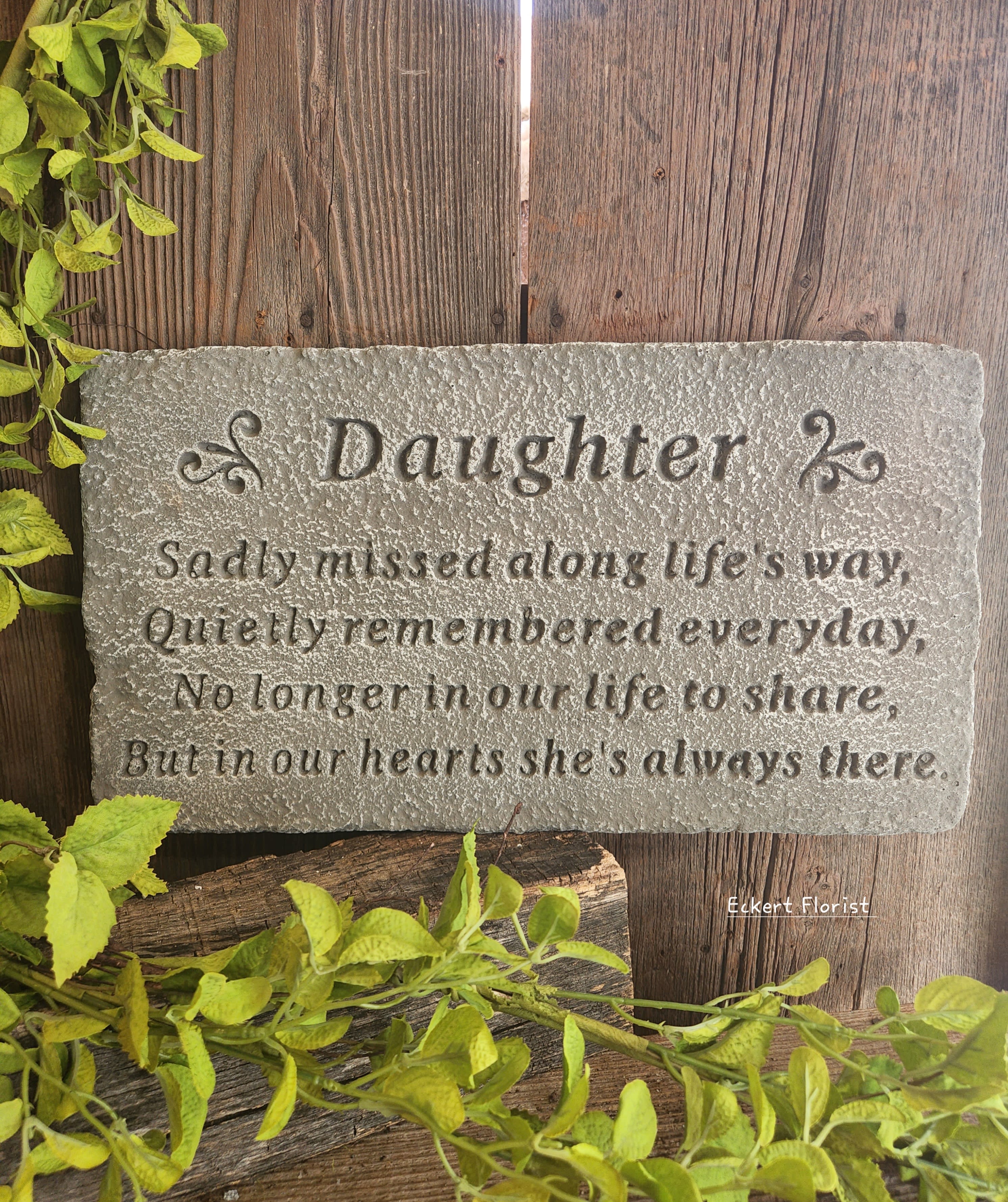 Eckert Florist's &quot;Daughter...&quot; Memorial Stone - *Our Local Delivery Only &quot;Daughter - Sadly missed along life's way, Quietly remembered everyday, No longer in our life to share, But in our hearts she's always there.&quot; Cement Stone measures approx. 10&quot; H X 17.5&quot; W *Stand Included *Upgrade with artificial flowers. See Deluxe option. ALL OF OUR STONES COME DECORATED WITH A SHEER BOW, WILLOW, RAFFIA, AND OUR SIGNATURE BIRD.