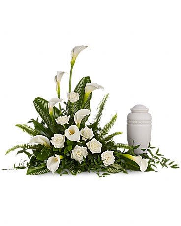 Stately Lilies - A calming portrait in ivory. Majestic calla lilies and stately white roses are framed by the lush leaves of aspidistra and calathea. Soft green sword fern adds to the soothing tones.