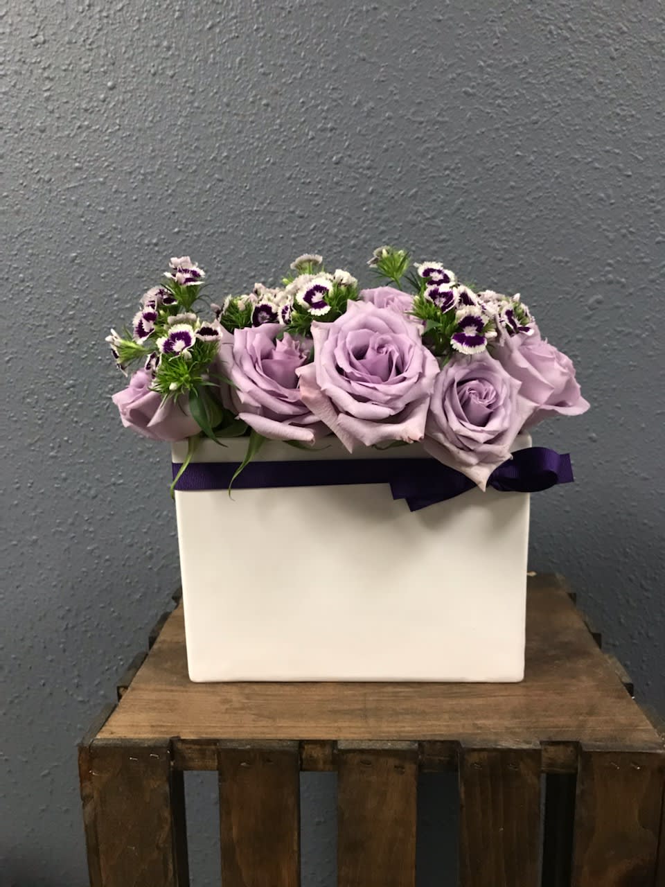 Royal Lavender - Approx Dimensions:  10L x 12H x 4W  Elegant arrangement with dozen lavender Roses, purple Dianthus and greens in a ceramic vase.