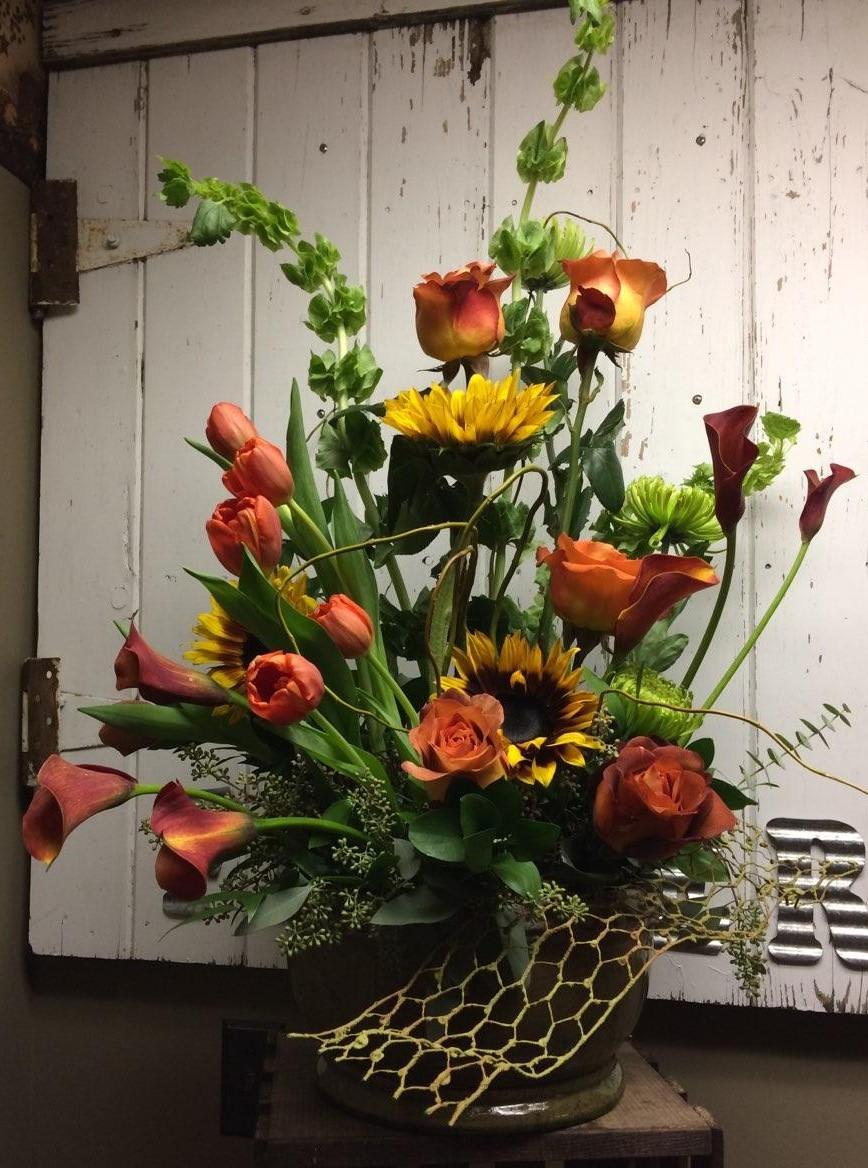 Timeless Traditons Custom Design by Cold Spring Floral Timeless Traditons Custom Design by Cold Spring Floral - Colorful mix of Sunflowers, Rust Miniature Calla Lilies, Orange Roses,Green Fuji Mums, OrangeTulips and Seeded Eucalyptus.