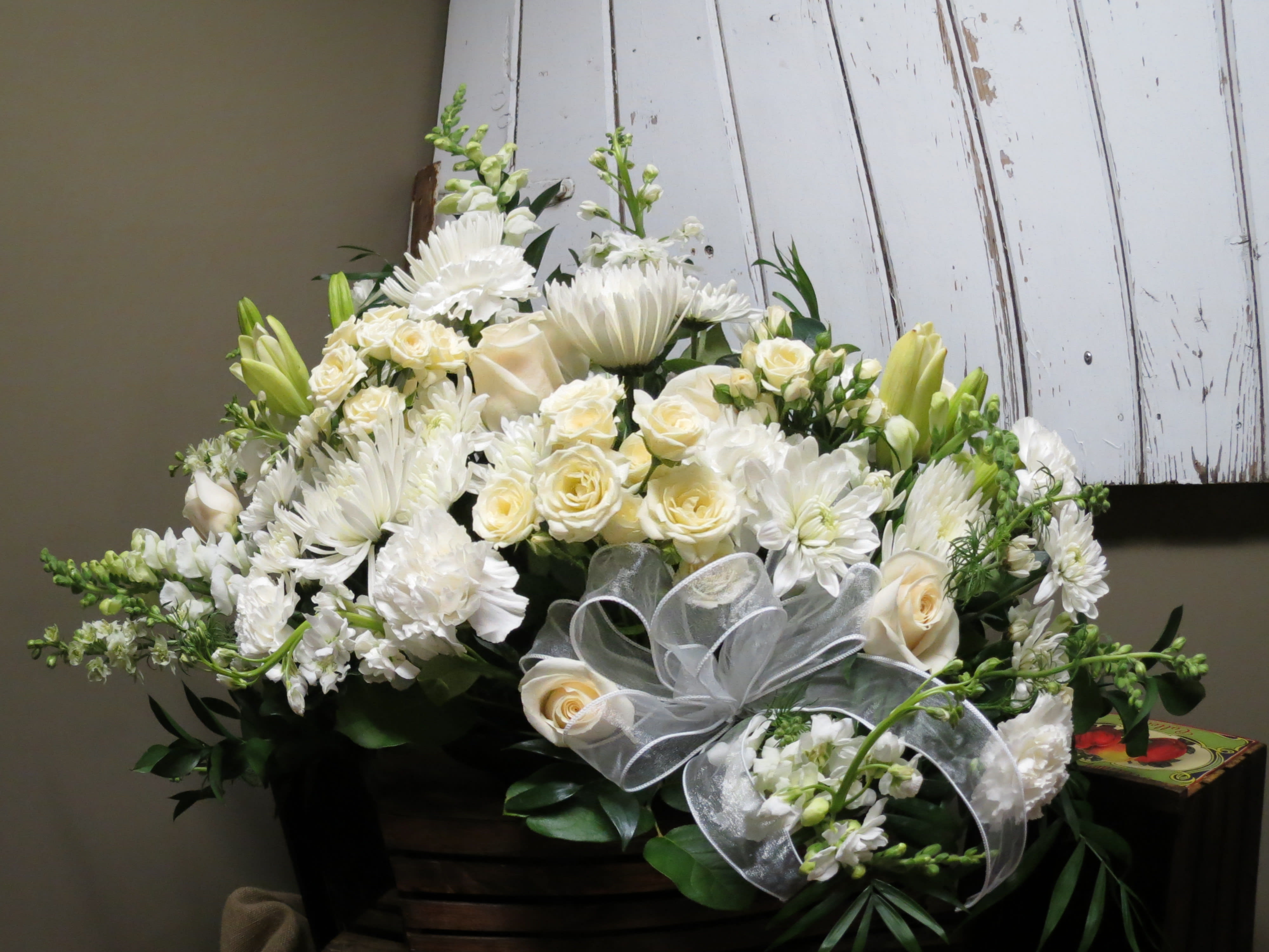 Simple Elegance Sympathy Custom Design by Cold Spring Floral -  An All White Bouquet containing a Mix of Roses, Carnations, Gladiolas, Fuji Mums, Spray Roses, Stock and Greenery in a Metal Container. Flowers and container subject to availability. 