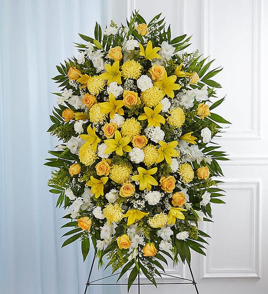 Yellow &amp; White Sympathy Standing Spray - Product Details : 1001-P-148715 A ray of hope can mean everything after the loss of a loved one. Both bright and abundant, our impressive standing spray arrangement, meticulously handcrafted by expert local florists with sunny yellow and rich white blooms, offers a grand gesture of peace, comfort and light during a difficult time.  Standing spray arrangement with yellow roses and daisy poms; white yellow Asiatic lilies , gladiola, yellow football mums , carnations and monte casino; accented with soft, lush greenery Large measures approximately 56&quot;H x 38&quot;L without stand Medium measures approximately 46&quot;H x 34&quot;L without stand Small measures approximately 42&quot;H x 30&quot;L without stand Arrives on an easel Appropriate for the funeral home or gravesite Our florists use only the freshest flowers available, so colors and varieties may vary due to local availability