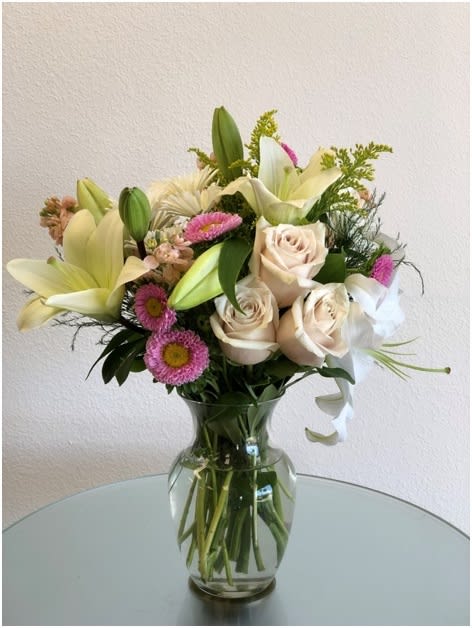ARRIVE IN STYLE ARRIVE IN STYLE - "This beautiful bouquet will most certainly arrive in style! Ready for the runway, as it were. A delightful combination of light colors and lovely flowers, it’s simply beautiful. Light pink roses, white Asiatic lilies, alstroemeria, cushion spray chrysanthemums and statice are delivered in a stylish vase. Style to spare! SET: All-Around All prices in USD ($)"