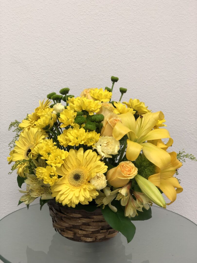BASKET FULL OF WISHES BASKET FULL OF WISHES - "Wishes do come true, by the basketful, actually. This delightful arrangement is so full of sunny blossoms, it even includes a pretty yellow butterfly who obviously feels right at home, basking in the warmth. Brilliant yellow spray roses, Asiatic lilies, miniature gerberas, carnations, alstroemeria, button spray chrysanthemums and delightful greenery are joined by a delicate butterfly in an oval basket. It’s a basket of wonder and wishes! SET: All-Around All prices in USD ($)"