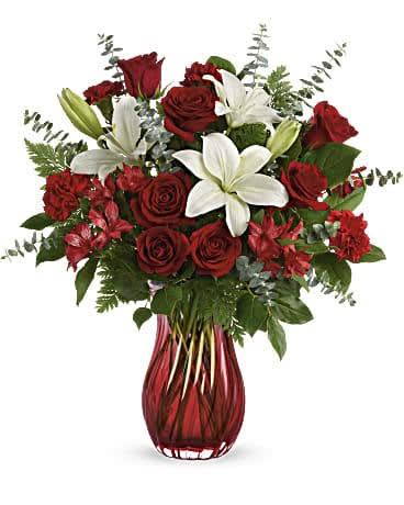 CONQUISTADOR CONQUISTADOR - "Give GRADUATION DAY a dramatic twist with this STUNNING, swirling glass vase. Its ruby red ombre hue is the perfect complement for ravishing red roses and snow-white lilies. Red roses, white Asiatic lilies, red alstroemeria, and red carnations are arranged with spiral eucalyptus, leatherleaf fern, and lemon leaf. Delivered in Teleflora’s Love Conquers All vase. SET: All-Around All prices in USD ($)"