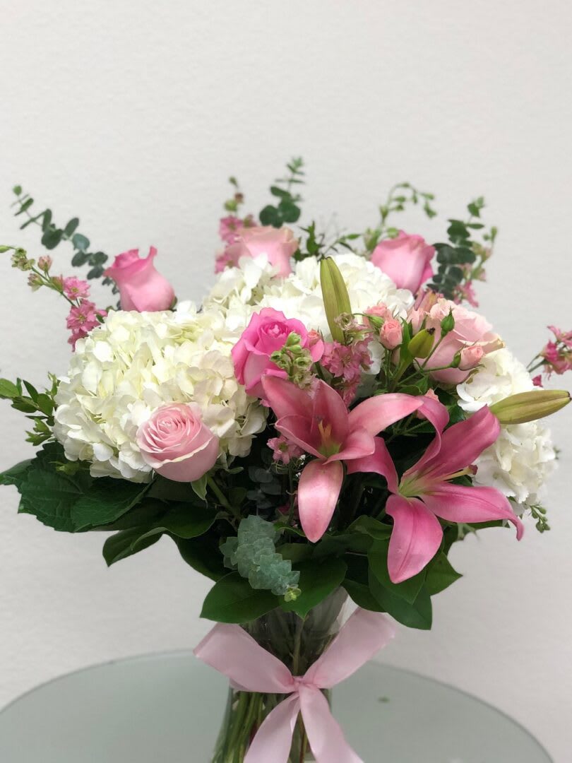 PASTEL PINK WITH WHITE HYDRANGEAS - &quot;Inspired by one of the world’s most incredible gardens, this garden of grace and beauty is delivered in one gorgeous bouquet. Among the beautiful mix of flowers, there is heartfelt hydrangea, lisianthus to show appreciation and delicate sweet pea because they’re not just pretty, they are well… sweet.  White hydrangea, pink stock and Lisianthus mix with light pink oriental lilies, pink roses, pink lakerskapure, pink spray roses, seeded eucalyptus and more. And it’s all perfectly arranged and delivered in an exclusive Couture Vase. Very pretty. Very proper.  SET: All-Around All prices in USD ($)&quot;