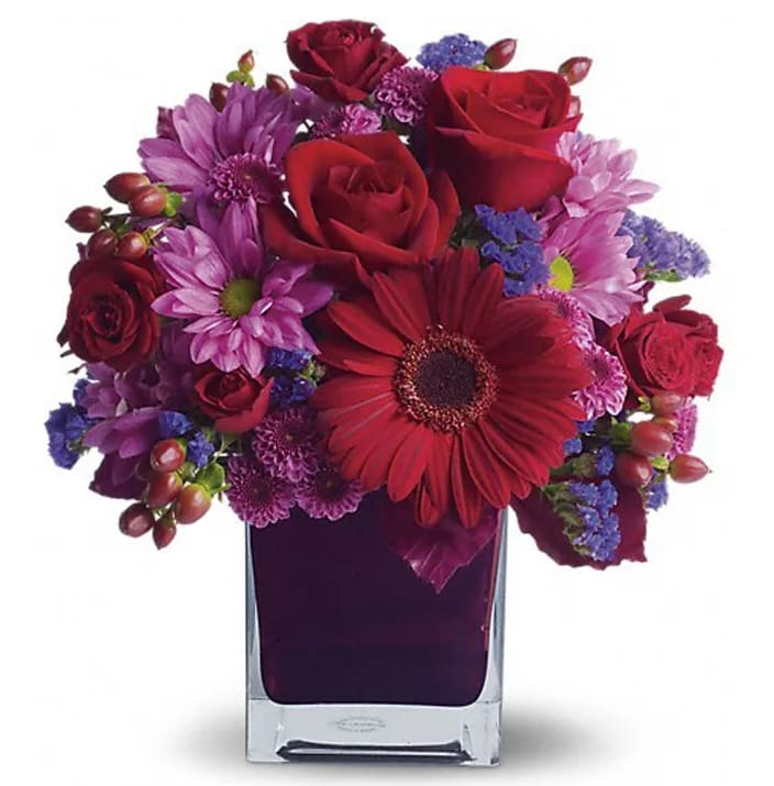  It's My Party [T173-1A] - The only crying that this plum party arrangement might inspire are tears of joy! So fabulous. So fun. So fall with its jewel-toned modern cube that's chock full of gorgeous red, purple and perfect flowers.  Red roses and gerberas, dark red spray roses, lavender chrysanthemums, purple statice and red hypericum are beautifully arranged in a plum cube vase. So get the party started!  Approximately 10 1/2&quot; W x 12&quot; H  Orientation: One-Sided      As Shown : T173-1A