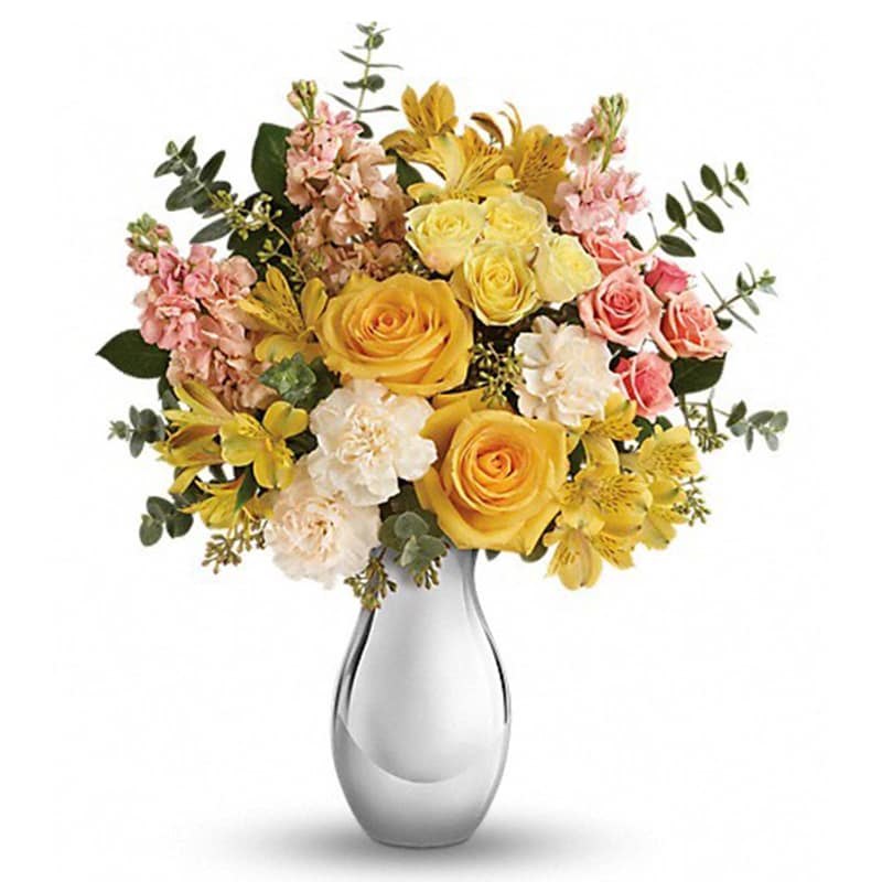 Soft Reflections [T600-3A] - Soft, sunshiny blooms and a sparkling silver vase combine to striking effect in this magnificent bouquet. Its yellow and peach roses and keepsake vase are sure to make them smile, no matter the occasion!  This soft mix of yellow roses, light yellow spray roses, peach spray roses, yellow alstroemeria, crème carnations and peach stock is accented with spiral and seeded eucalyptus. Delivered in a Silver Reflections vase.  Approximately 16 1/2&quot; W x 20&quot; H  Orientation: All-Around      As Shown : T600-3A