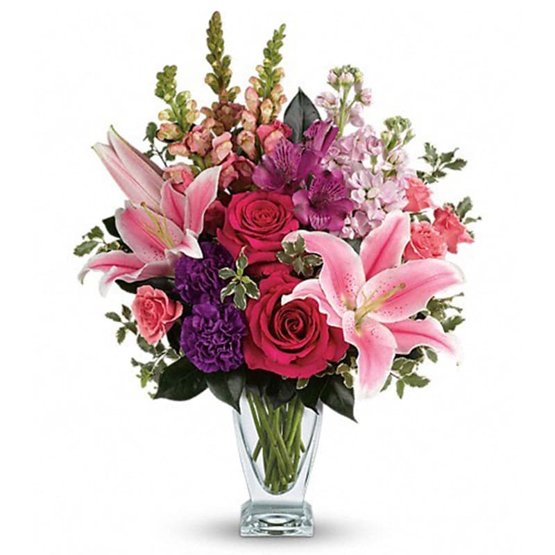 Morning Meadow Bouquet [T600-7A] - Hand-delivered in a shapely glass vase, this sumptuous arrangement of roses and lilies is a lavish way to celebrate a special day - or surprise someone just because!  Hot pink roses, pink spray roses, pink oriental lilies, purple alstroemeria, purple carnations, light pink stock and pink snapdragons are arranged with pitta negra and camellia leaves. Delivered in a clear Couture vase.  Approximately 15 1/2&quot; W x 20&quot; H  Orientation: All-Around      As Shown : T600-7A