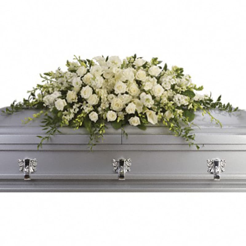 Purity and Peace Casket Spray [T229-3A] - A stunning yet respectful testament in white, this spray for the casket includes roses, orchids, calla lilies and hydrangea accented by soft, trailing greens.  White roses, orchids, large calla lilies and perfect stems of hydrangea. Approximately 47&quot; W x 17&quot; H.  Approximately 47&quot; W x 17&quot; H  Orientation: N/A  As Shown : T229-3A