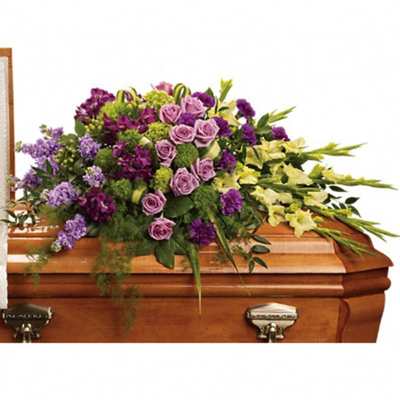 Reflections of Gratitude Casket Spray [T268-3A] - Devotion is beautifully expressed with lavender roses, purple alstroemeria and other favorites artistically arranged and placed on top of the casket.  The lush arrangement includes green miniature hydrangea, lavender roses, purple alstroemeria, green gladioli, green trick dianthus, purple carnations, lavender stock and green hypericum, accented with assorted greenery.  Approximately 47&quot; W x 30&quot; H  Orientation: N/A  As Shown : T268-3A