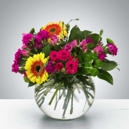 Meadow Magic by BloomNation™ - A bright bubble arrangement featuring button mums, gerbera daisies, and spray roses, this arrangement makes a lovely thank you or just because gift.  Approximate Dimensions: 12''D x 12''H