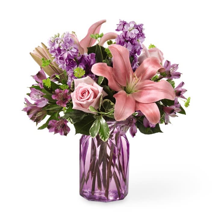 Full of Joy - There’s something about a charming mix of pink and purple florals that puts a spring in our step! Fresh lilies, roses and stock add an array of beautiful texture in our Full of Joy bouquet. Its bursting hues and bright blooms are perfect to celebrate this season.  The container here is lavender but we may substitute with an equally springy vase - in fresh colors of pink/green/lavender...