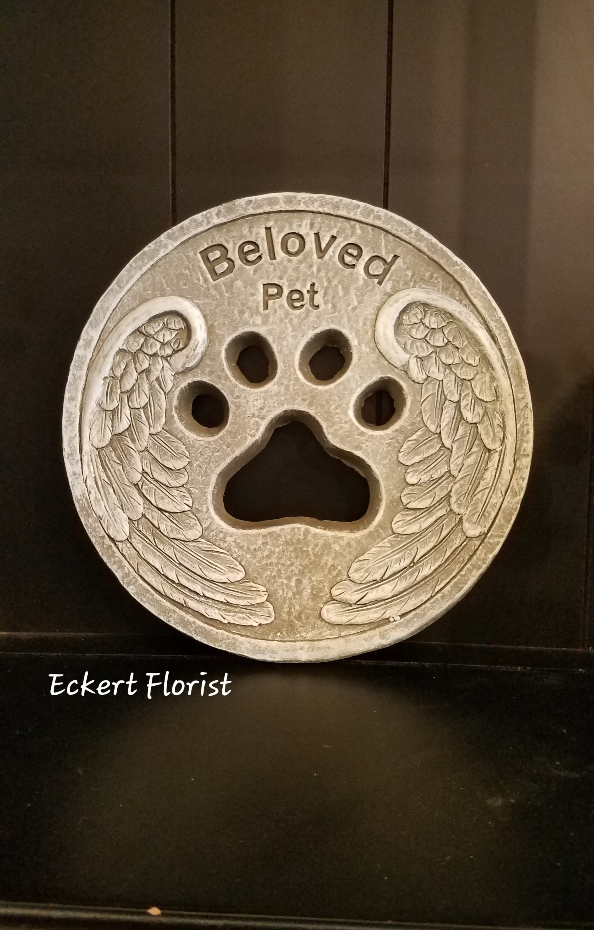Eckert Florist's Beloved Pet Memorial Stone *OUR LOCAL DELIVERY ONLY  - This cement stone is a perfect memorial keepsake for a beloved pet. *Stone measures approx. 11.5&quot; Diameter *May be added to a fresh arrangement or green plant. See Deluxe and/or Premium upgrades. *See Add-on Section for Display Easel