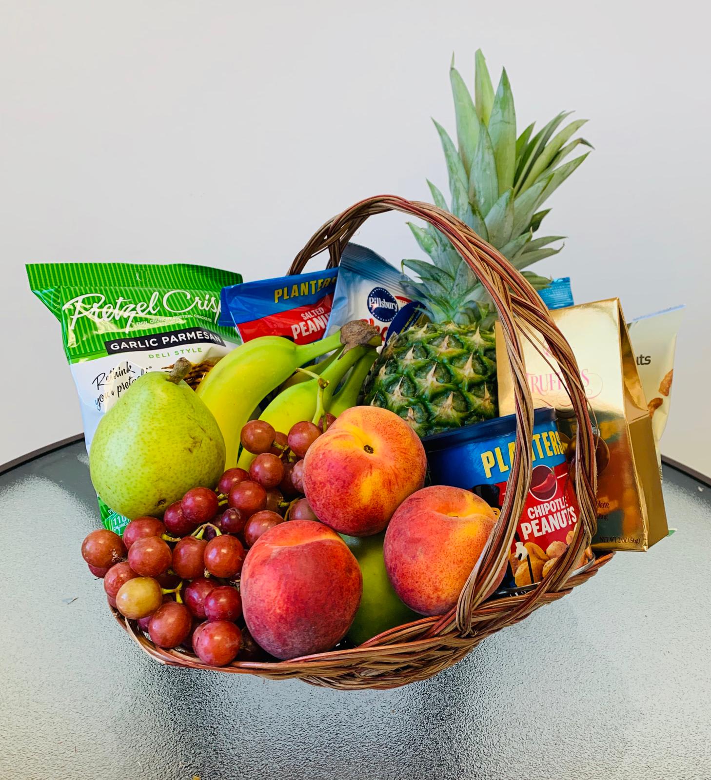 Tropical Basket Tropical Basket - Mix of tropical fruits like Pineaple, grape, apples and others delicious gourmet items