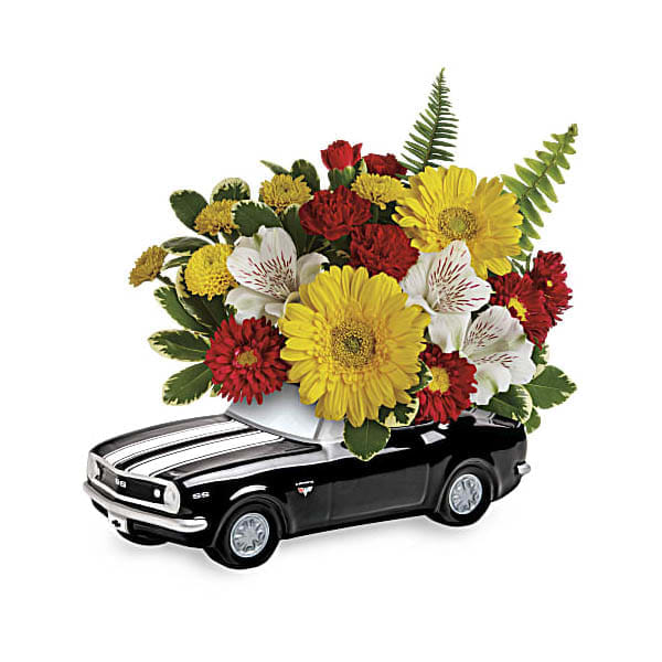 '67 Chevy Camaro Bouquet - Get his motor running this Father's Day with this fun-filled flower gift! Red, yellow and white blooms burst from the back of of a '67 Chevy Camaro, a sleek ceramic keepsake that's just about as cool as he is!  This colorful arrangement includes miniature yellow gerberas, white alstroemeria, red miniature carnations, red matsumoto asters, yellow button spray chrysanthemums, variegated pittosporum and sword fern. Delivered in a '67 Chevy Camaro keepsake  Approximately 12&quot; W x 10 1/4&quot; H