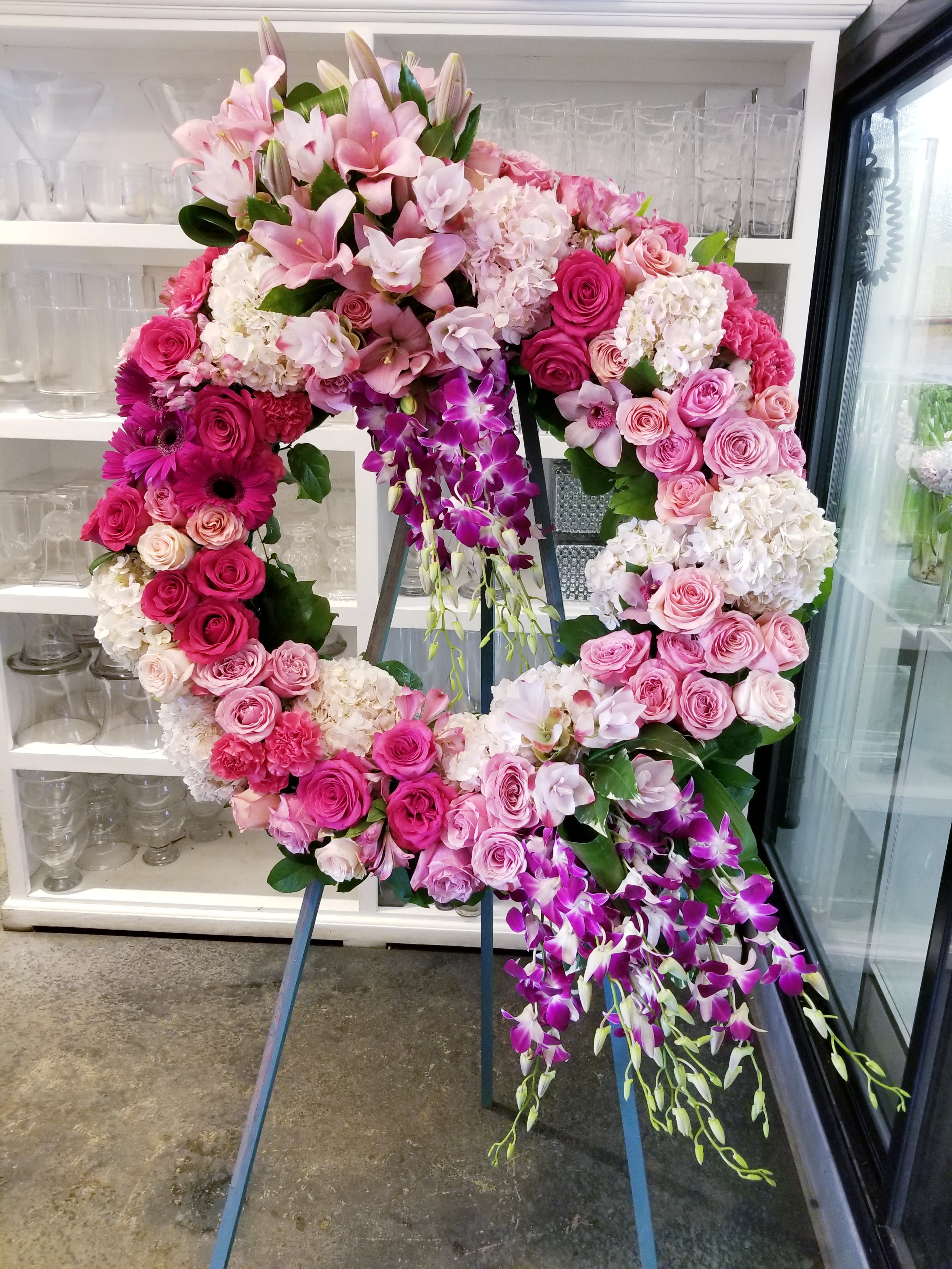 Pink Wreath - Funeral wreath on an easel in shades of pink and a touch of white.