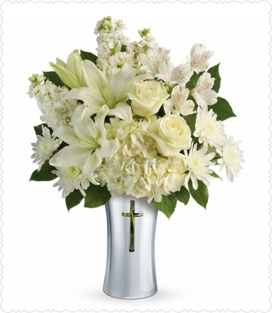Shining Spirit Bouquet - Show your sympathy with style and grace. A shining silver finish and reverent cross cut-out makes this stunning ceramic vase the perfect accompaniment for a lush bouquet of pure white hydrangea, lilies, alstroemeria and stock. White hydrangea, white asiatic lilies, white alstroemeria, white stock, and white cushion spray chrysanthemums are accented with lemon leaf. Delivered in a Shining Cross vase.