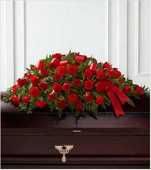 The Dearly Departed Casket Spray - The Dearly Departed Casket Spray bursts with the love and passion that the deceased had for their life and loved ones. Rich red roses and carnations are gorgeously arranged amongst lush greens and accented with a red satin ribbon to create the ideal adornment for their casket at their final farewell service. Approximately 40&quot;L x 26&quot;W. Your purchase includes a complimentary personalized gift message.