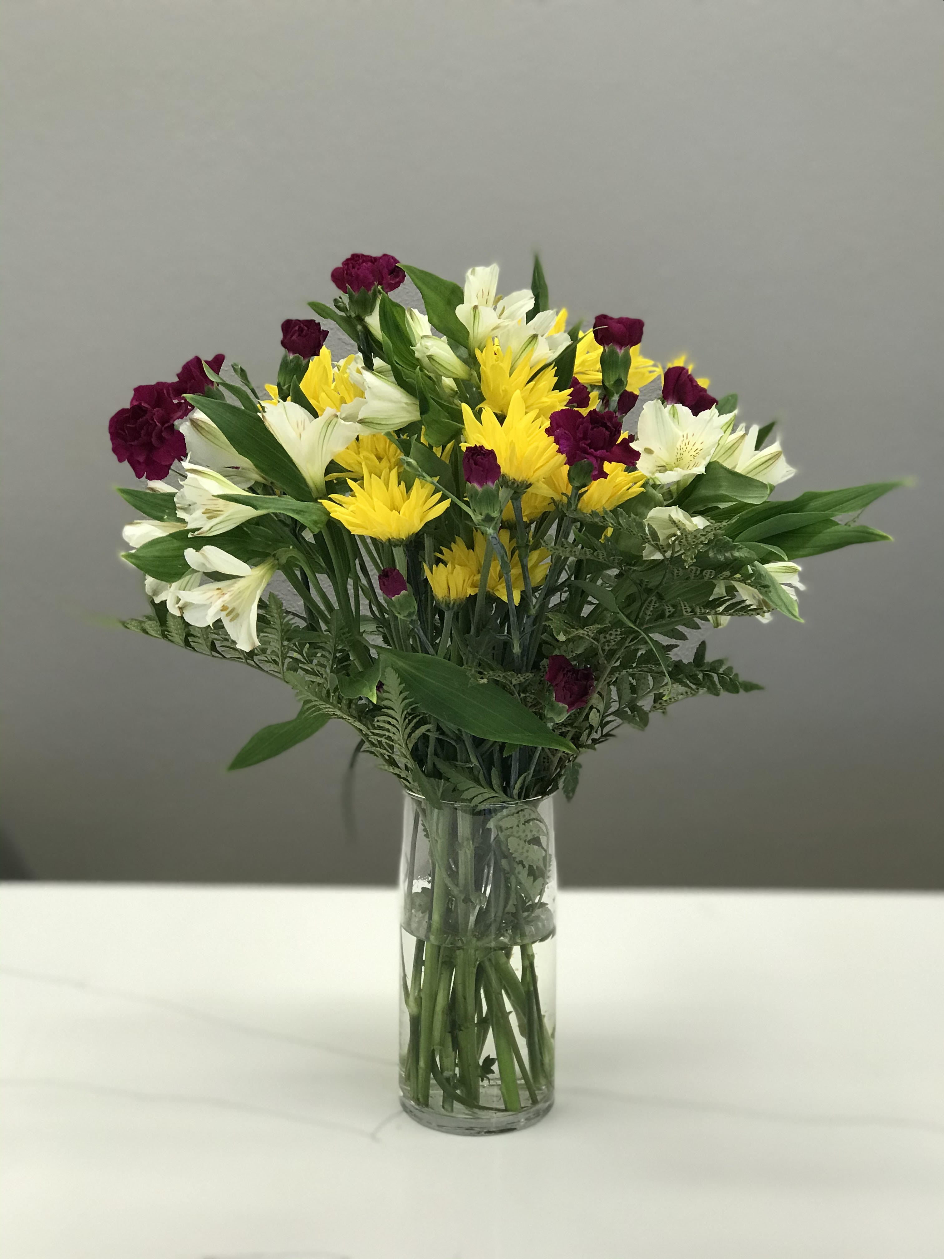 Just Because  - Simple and bright this arrangement is poised and price to remind a loved one their special. Just because. 