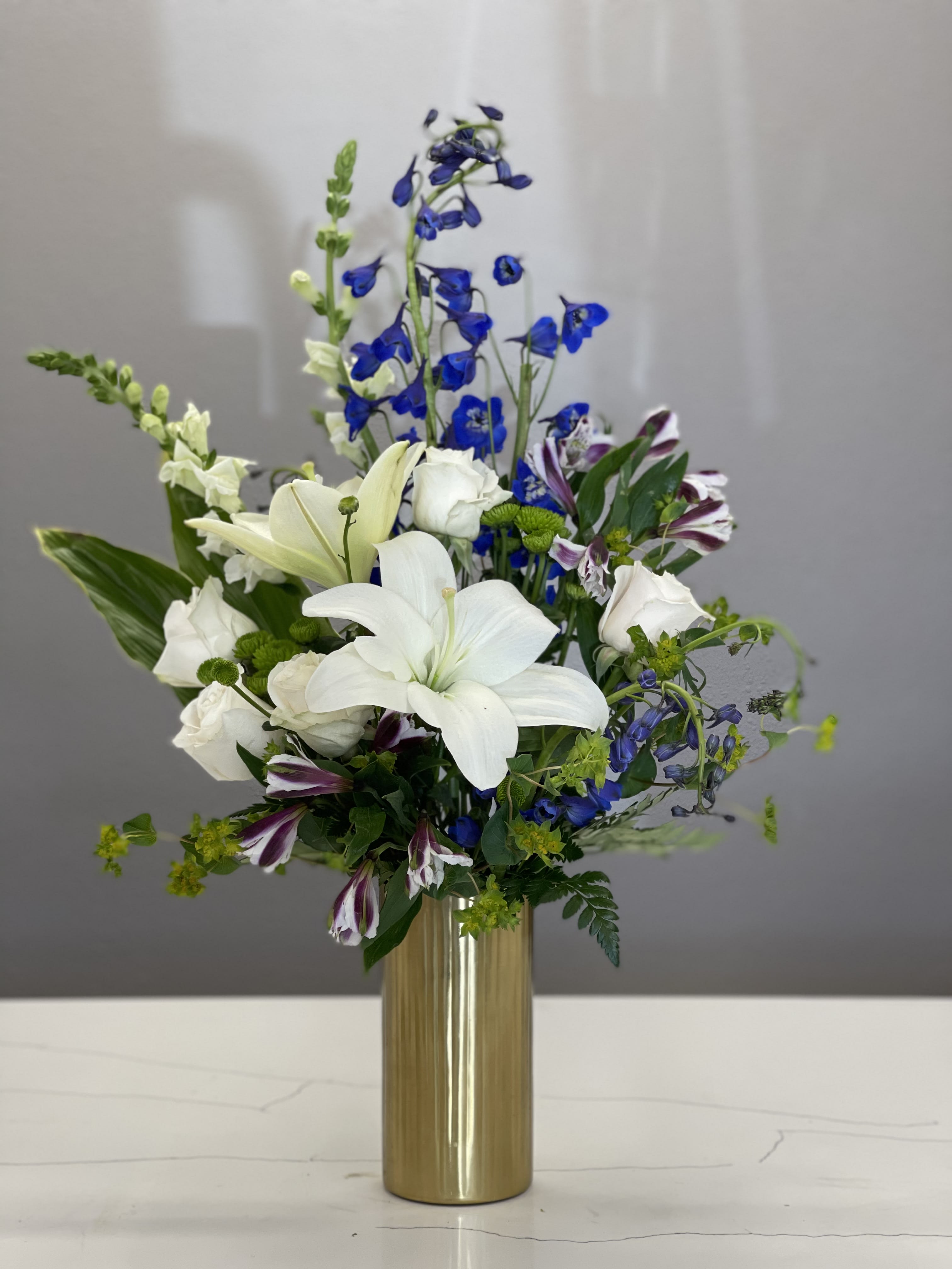 Miss Independent - White roses and lilies are in the middle of Matisse's &quot;Dance&quot; as the colorful blooms show movement around a previously empty center. Send as a fun surprise today!