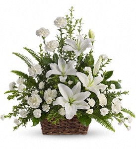 Peaceful White Lily Basket - Whether you send this beautiful arrangement to the family home or to the service, all will appreciate its elegance and grace. The contrast of brilliant white blossoms and dazzling greenery create a wonderfully calm and dignified setting.