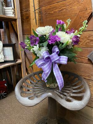 Purple Skies  - This beautiful arrangement contains stock, Mums, carnations and all the best white and purple flowers the season has to offer. 