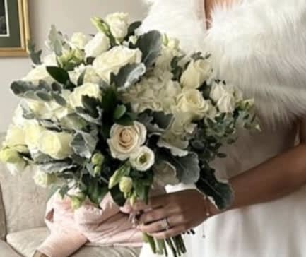 Whimsical Whites Whimsical Whites - This beautiful organic styled bouquet is textured and filled a variety of florals and greens such as Dusty Miller, White Hydrangea, White Garden Roses, White Roses, White Spray Roses, White Lisianthus, Gunni Eucalyptus and Israeli Ruscus