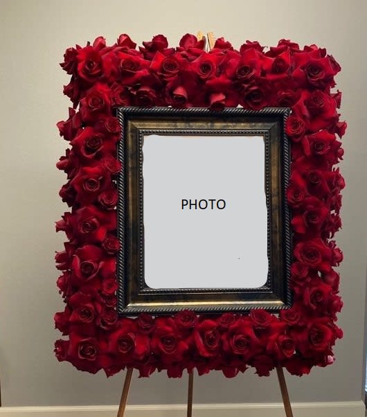 Memorial Frame Spray 2 - This luxurious frame spray is designed by Kenneth Village Flowers as an addition to any memorial service. This arrangement is prepared with high red roses to highlight your love and respect.