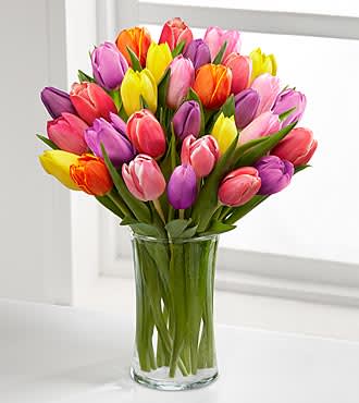 Tulip Vase - What better way to say I Love Your or Thinking of You with a Beautiful Vibrant Colored Tulip Vase.   25 Assorted tulips (2-3 colors guaranteed as long as available) carefully selected and designed in a vase...