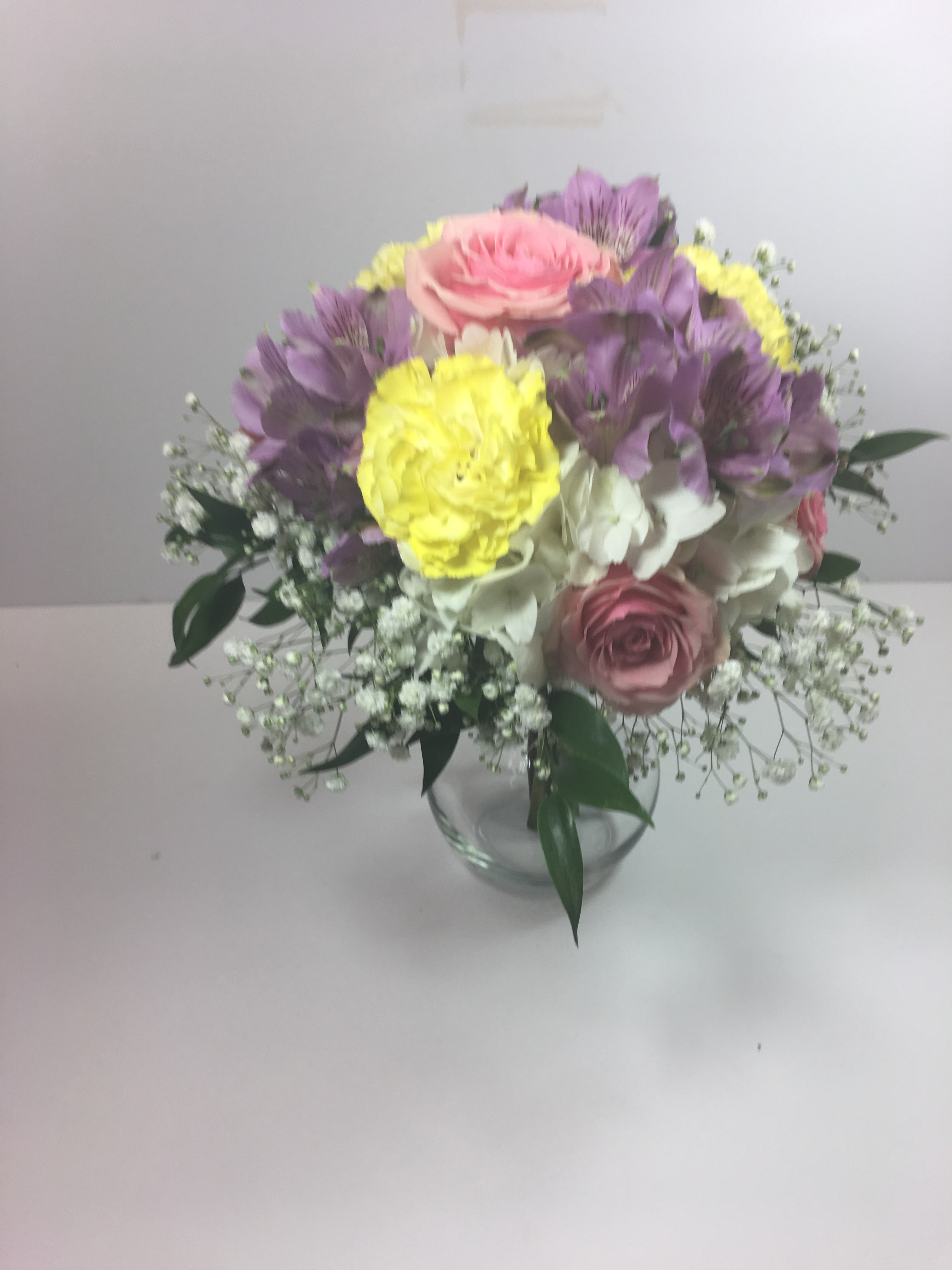 C10 Prom Clutch of mixed flowers  - Spring colored prom bouquet of hydrangea, roses, alstromaria and carnations.  Each prom selection is customized for your date and her beautiful dress.