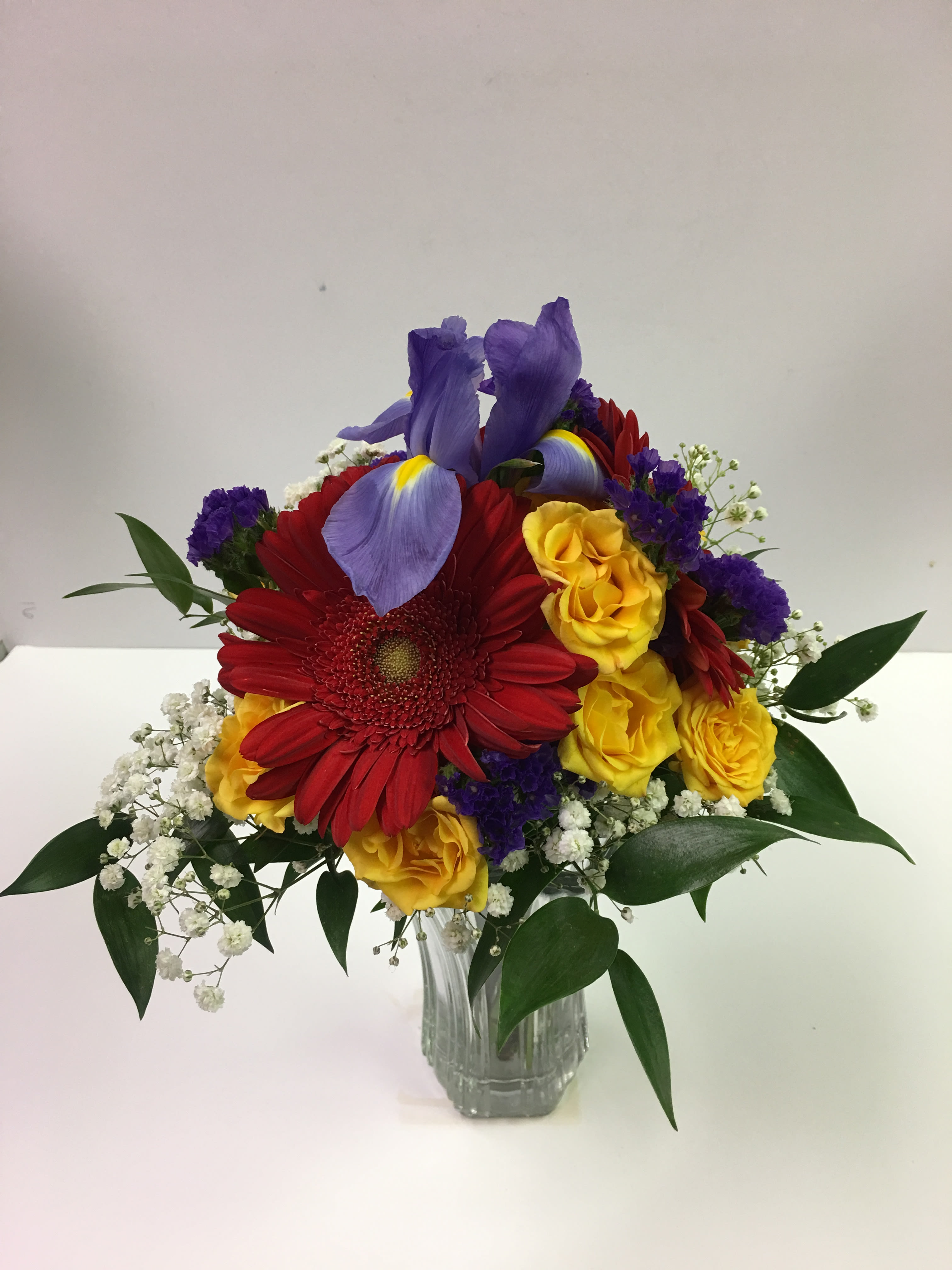 C31 Bright Floral Prom Clutch - This clutch features gerbera daisies, spray roses and irises.    Your prom order is customized for your date and her beautiful dress.