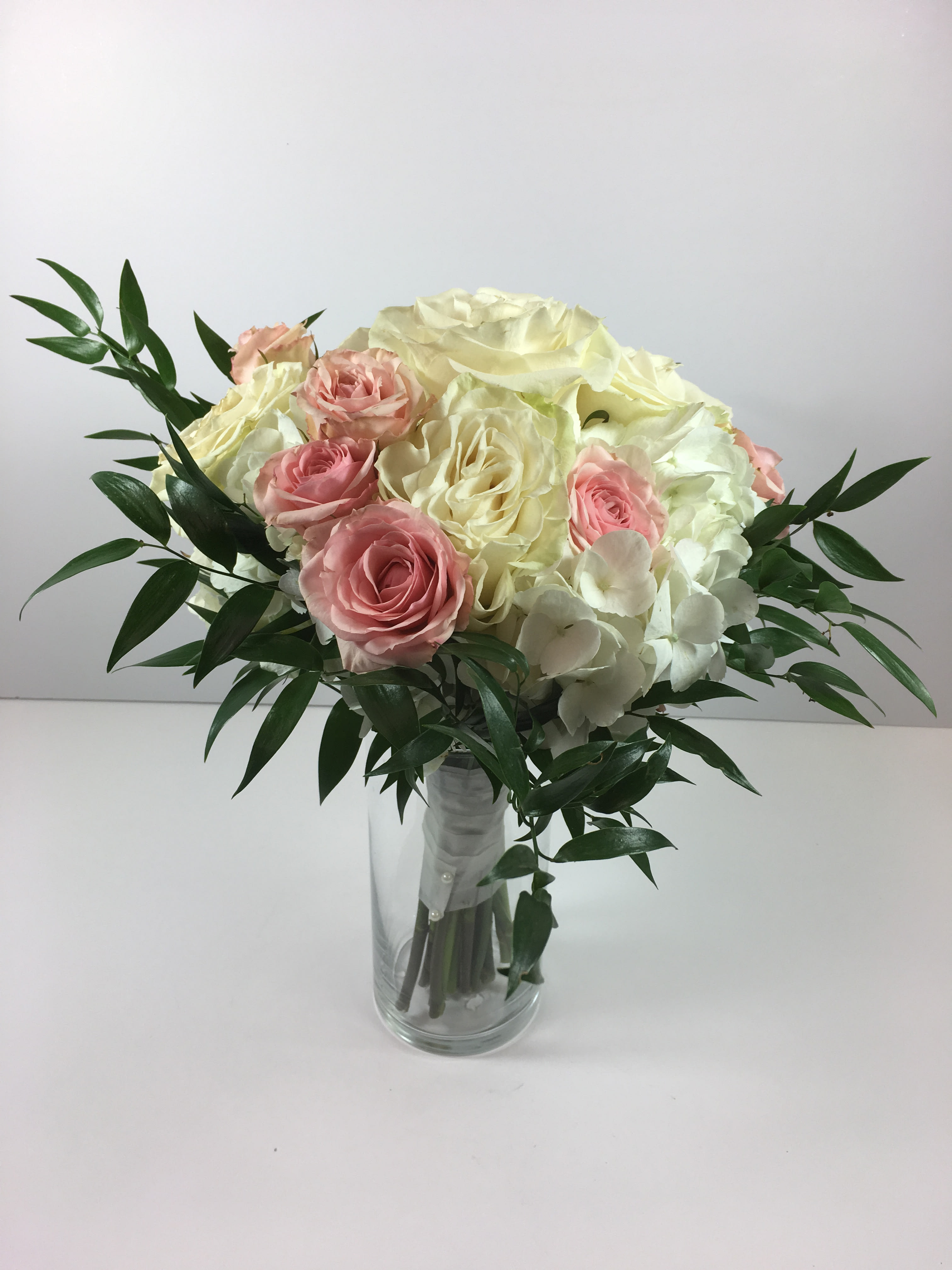 C43 Grand prom clutch C43 Grand prom clutch - This clutch features hydrangea, roses, spray roses and beautiful greenery. We can customize colors to go with your date's beautiful dress!