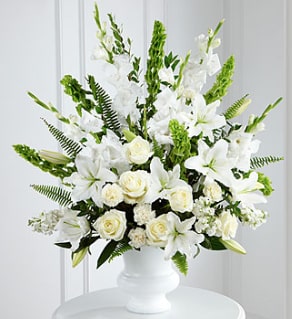 S2-4438 - White roses, carnations, gladiolus, stock and Oriental lilies are accented with the bright green stems of Bells of Ireland. Also available in other colors, please inquire!