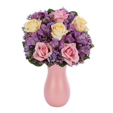 She Is Love Bouquet She Is Love Bouquet - She is special, she is unique, she is mom and the thoughts are all about the love you have for her as this stunning floral creation expresses your feelings perfectly. Pink and cream roses, lavender alstroemeria, pink waxflower and lavender statice are expertly arranged in a pink keepsake shimmer vase. Small Measures 14?H X 8?L. Medium Measures 15?H X 9?L. Large Measures 16?H X 10?L