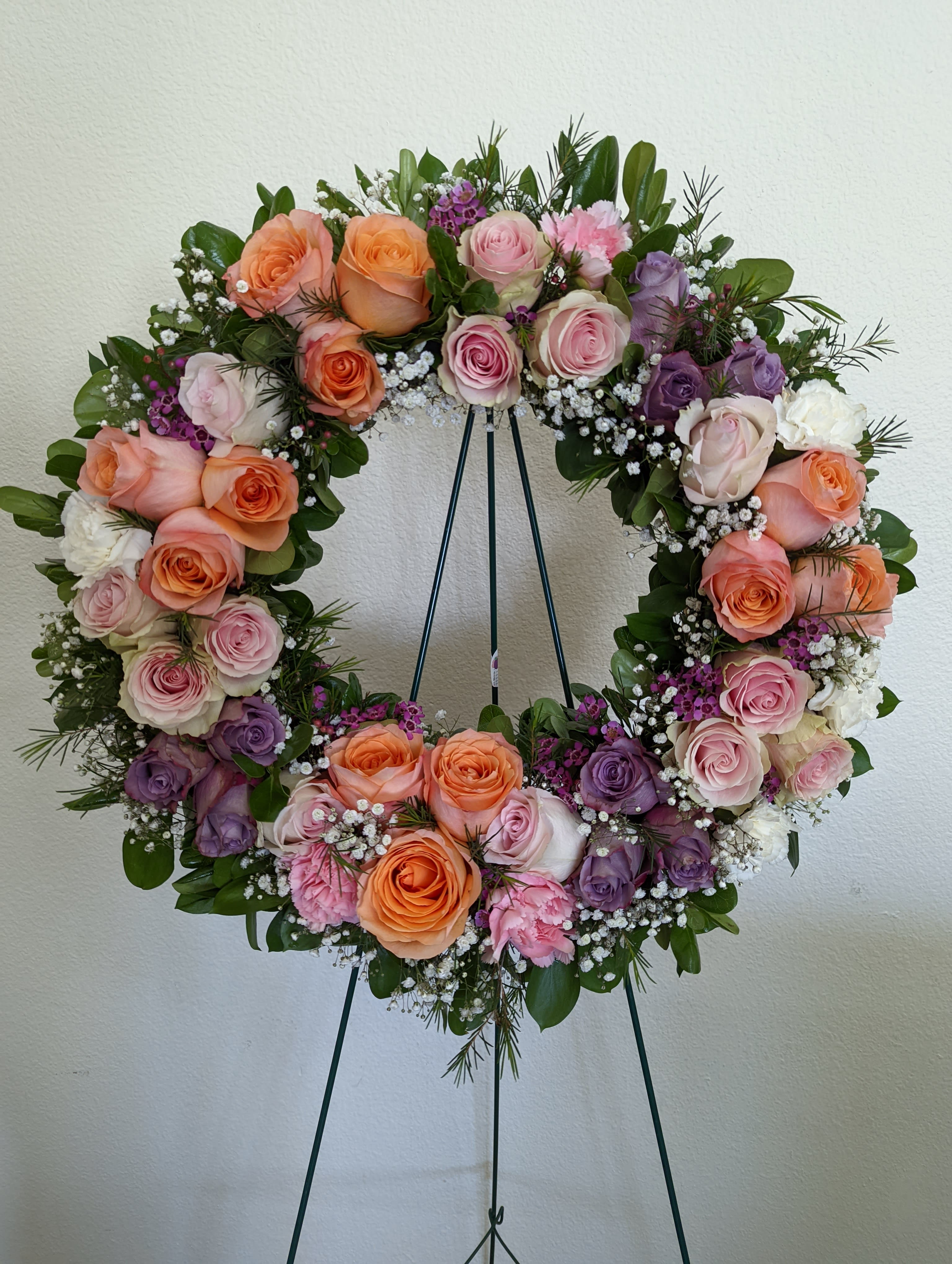 In Memory In Memory - Let our wreath arrangement say your heartfelt condolences and sympathy. This is 15" wreath size with a mix roses, and baby's breath.