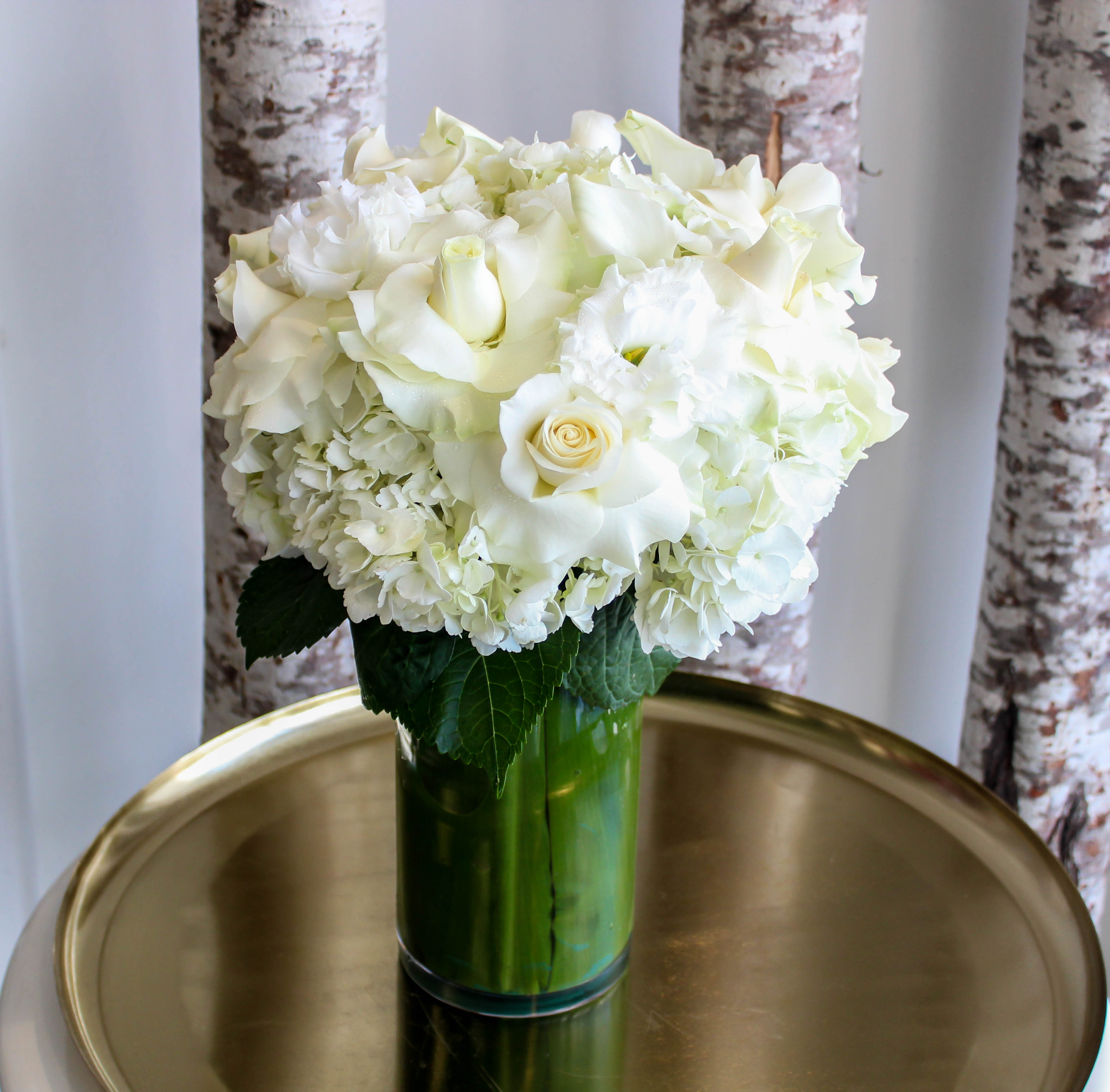 White Diamond - A taller vase arrangement of white premium floral choices including white roses, hydrangea, and more. A clean and chic design that adds a living touch of elegance to your spaces. Measures Approximately 20&quot; Height  and 15&quot; Width 