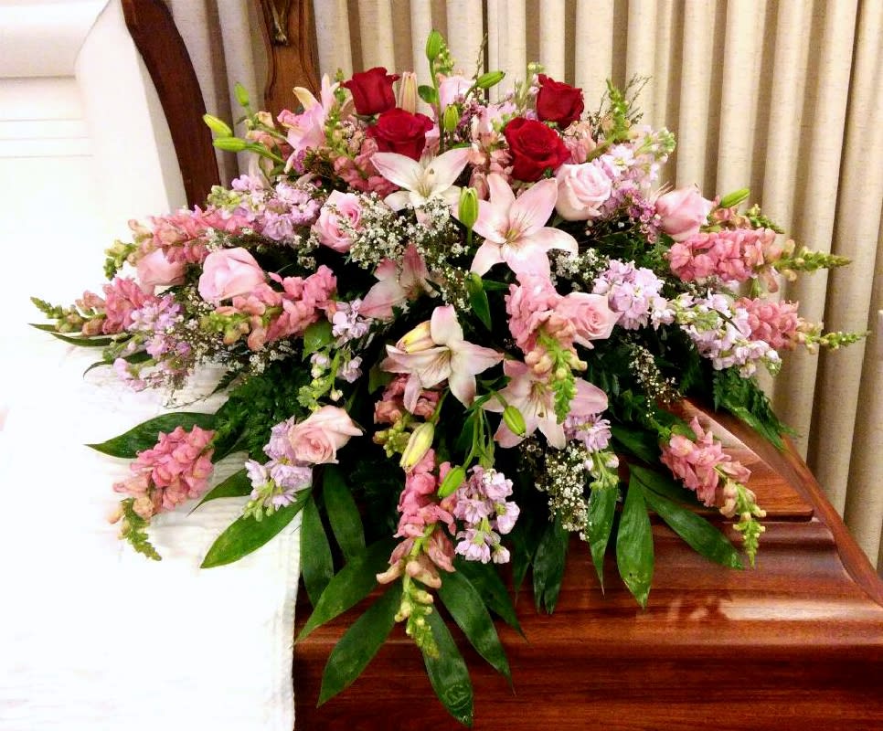 Soft Pastels Casket Spray Soft Pastels Casket Spray - Made wit assorted pink and white spring flowers, the 4 red roses are optional which represented the children of the deceased in this arrangement..