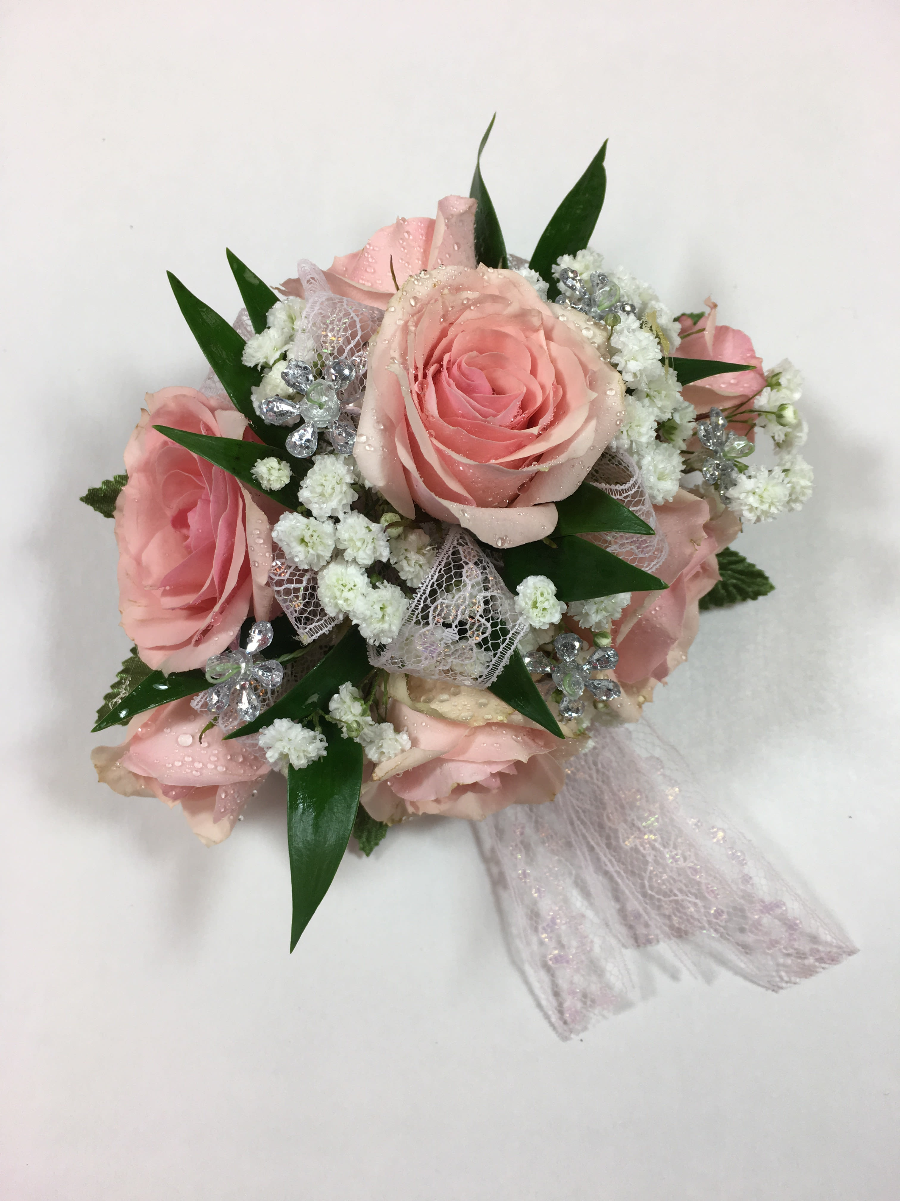 W3 Spray Rose Wrist Corsage  - Delicate feminine design with lace ribbon.  Spray roses are the focus of this design.  Pictured with silver jewels.   Each corsage is customized to go with her beautiful dress.  Want to make your date's night? Add a lovely keepsake bracelet! 