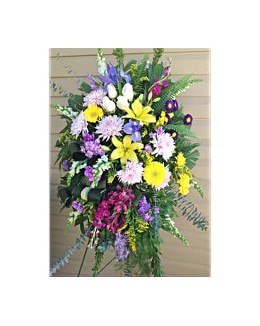 Bright Memories Standing Spray Bright Memories Standing Spray - In the hand arranged standing spray you see yellow Lilies Iris lavnder Fugi Mums purple and pink Stock yellow Gerber Daisies white Snap Dragons purple Carnations purple Alstroemeria and purple Asters. All flowers and colors are subject to change due to availability. FCF-0280