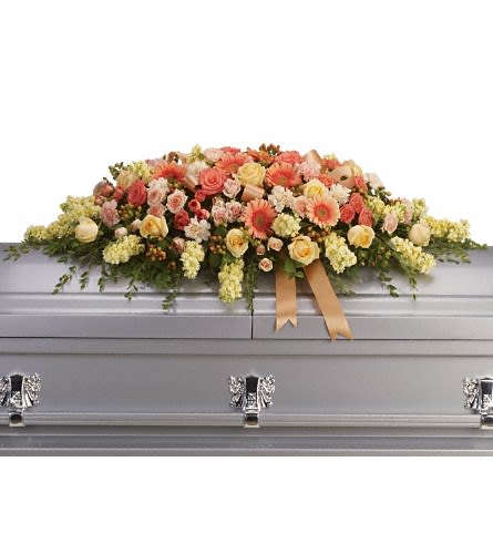 Warmest Remembrance Casket Spray Warmest Remembrance Casket Spray - This tastefully colorful casket spray is not only a tribute to a lost loved one but a reminder of the many joyous times spent together. The beautiful bouquet includes peach roses light pink spray roses coral spray roses light orange gerberas light orange carnations light yellow stock and peach hypericum accented with satin ribbon and assorted greenery.Approximately 50" W x 17 1/2" H Orientation: N/A As Shown : T266-3A