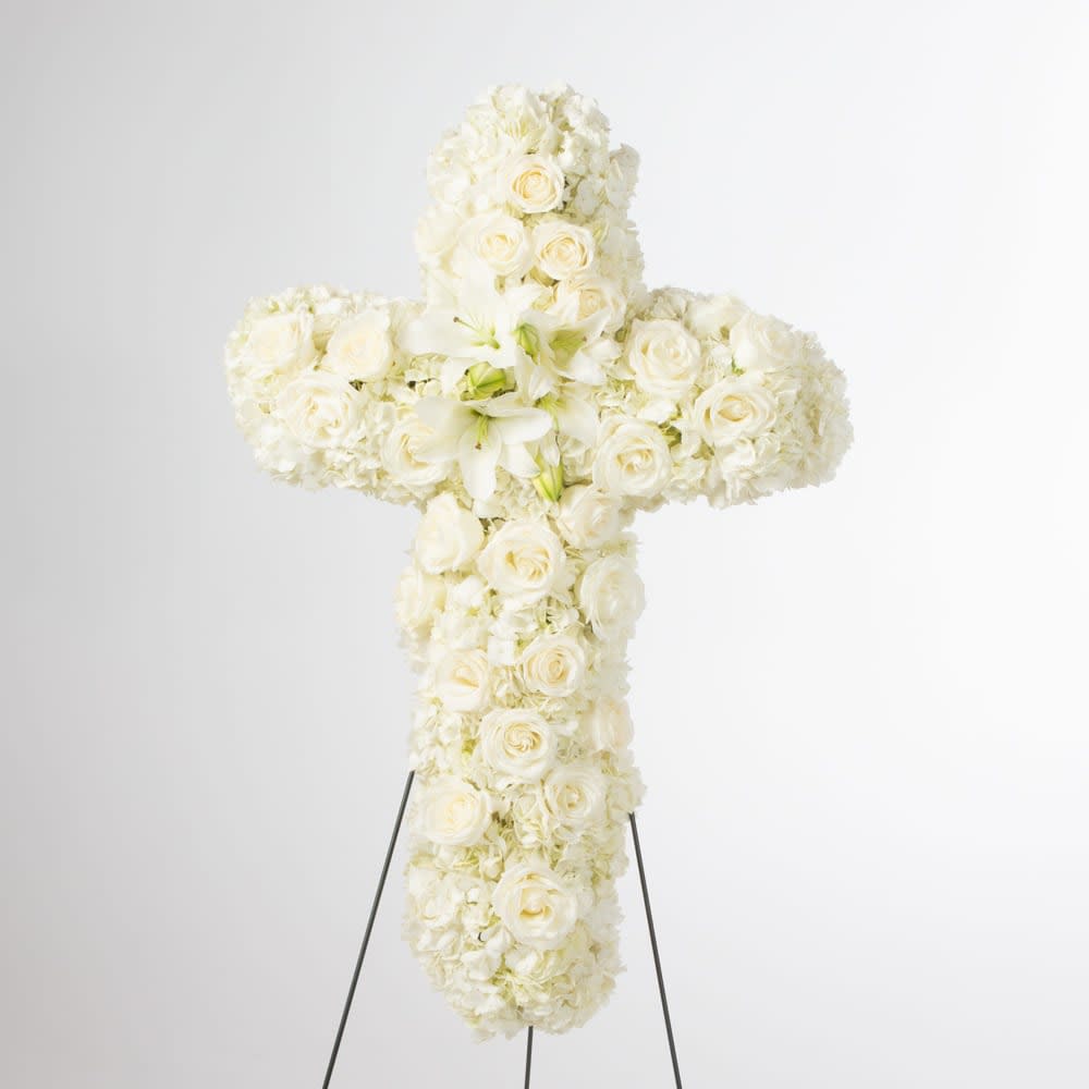 Faith  - An all white tribute, this white cross funeral spray is pure and tranquil. Featuring a variety of white flowers, this elegant easel compliments the beauty of life. 
