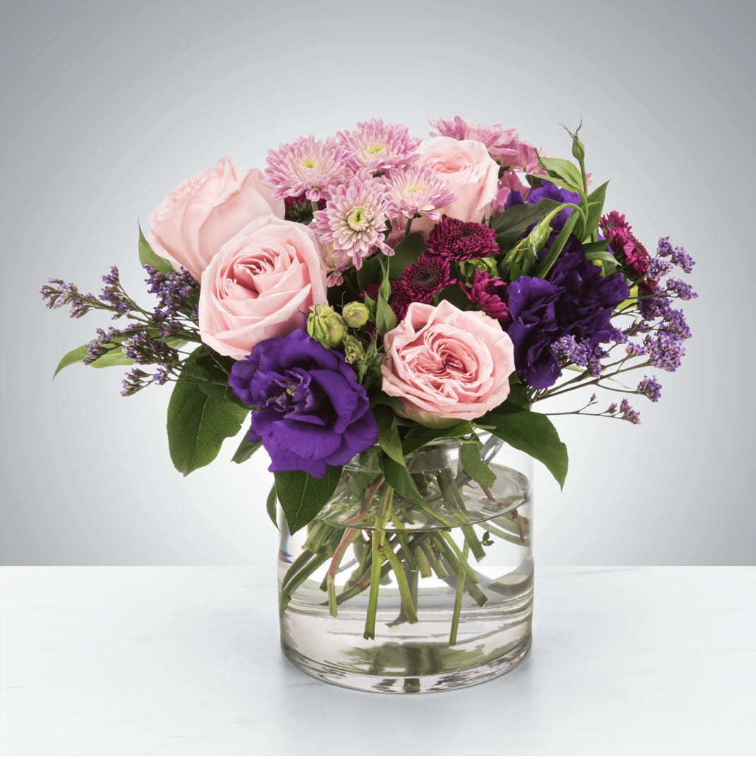 Designer's Choice: Home Sweet Home - A selection of pink and purple flowers come together in an eye-pleasing arrangement. This arrangement makes a great gift for Mother's Day, Women's Day, or as a thinking of you present.  